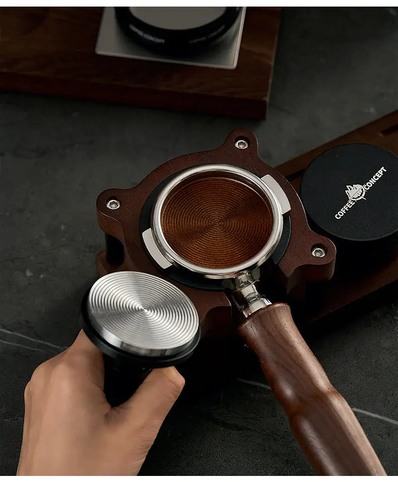 Espresso tamper and WDT distribution head with wooden handle, portafilter basket open view.