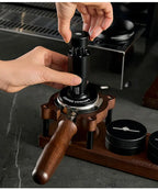 Black espresso tamper with wooden handle and WDT distribution tool on wooden stand