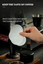 White coffee filter paper discs held above a portafilter basket