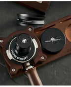 Black tamper and WDT tool set on wood stand with Coffee Concept logos
