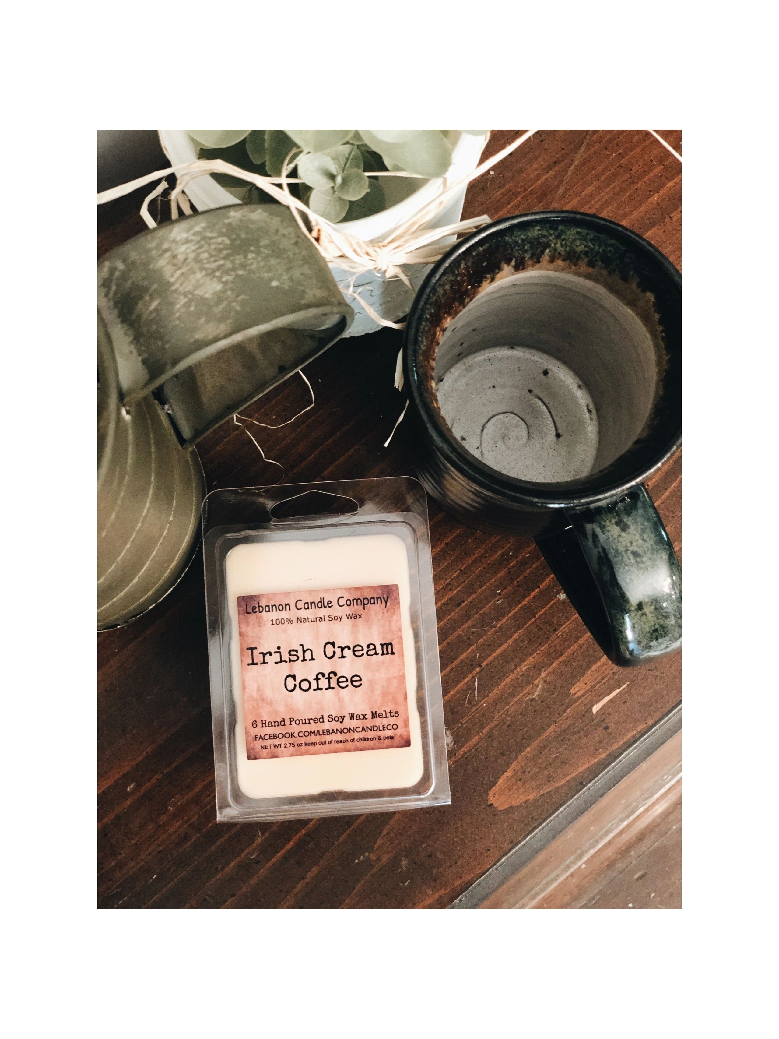 Soy wax melt clamshell labeled 'Irish Cream Coffee' with a wax warmer nearby
