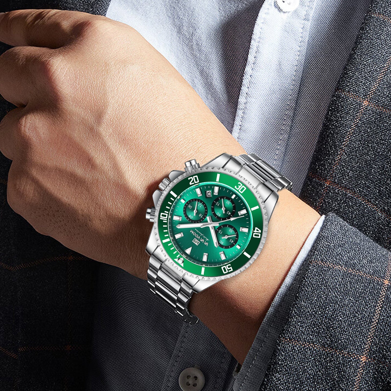Men's two-tone wristwatch on wrist with green dial and multi-dial chronograph design