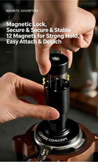 Black 58mm espresso tamper with WDT distribution tool attachment, used by hand on portafilter.
