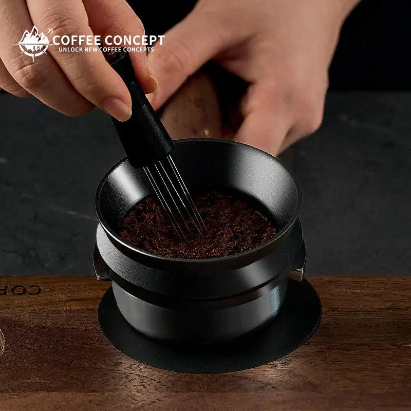 Black magnetic powder ring under a dosing tool, with espresso grounds inside the funnel.