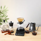 All-in-one pour-over coffee set with glass dripper, grinder, kettle, server, mugs