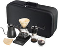 Portable pour-over coffee brewing kit in black travel bag with kettle, dripper, grinder and cups