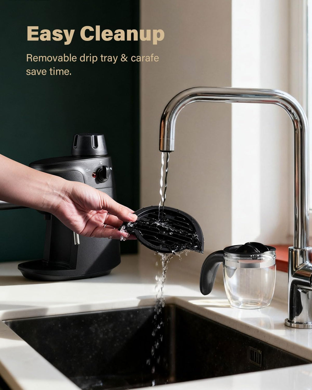 Black espresso machine with removable drip tray being rinsed at sink, stainless faucet