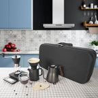 Pour-over coffee maker kit in black travel case with grinder, kettle, dripper, scale
