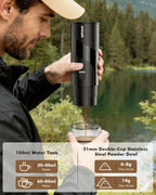 Portable electric espresso maker pouring coffee into a clear cup