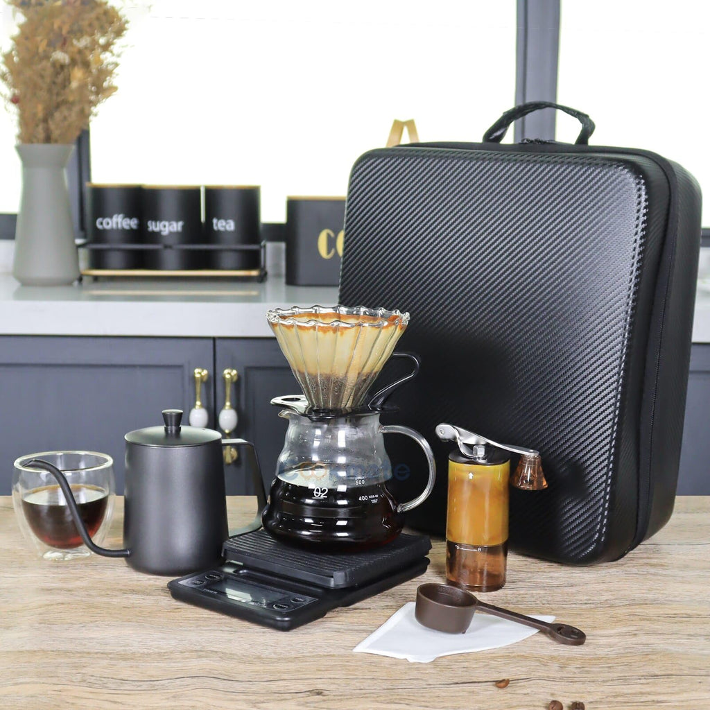 Countertop pour-over coffee brewer with glass carafe, kettle, and black zippered travel case