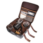 Opened coffee kit travel bag with glass server, kettle, dripper, filters, and grinder parts
