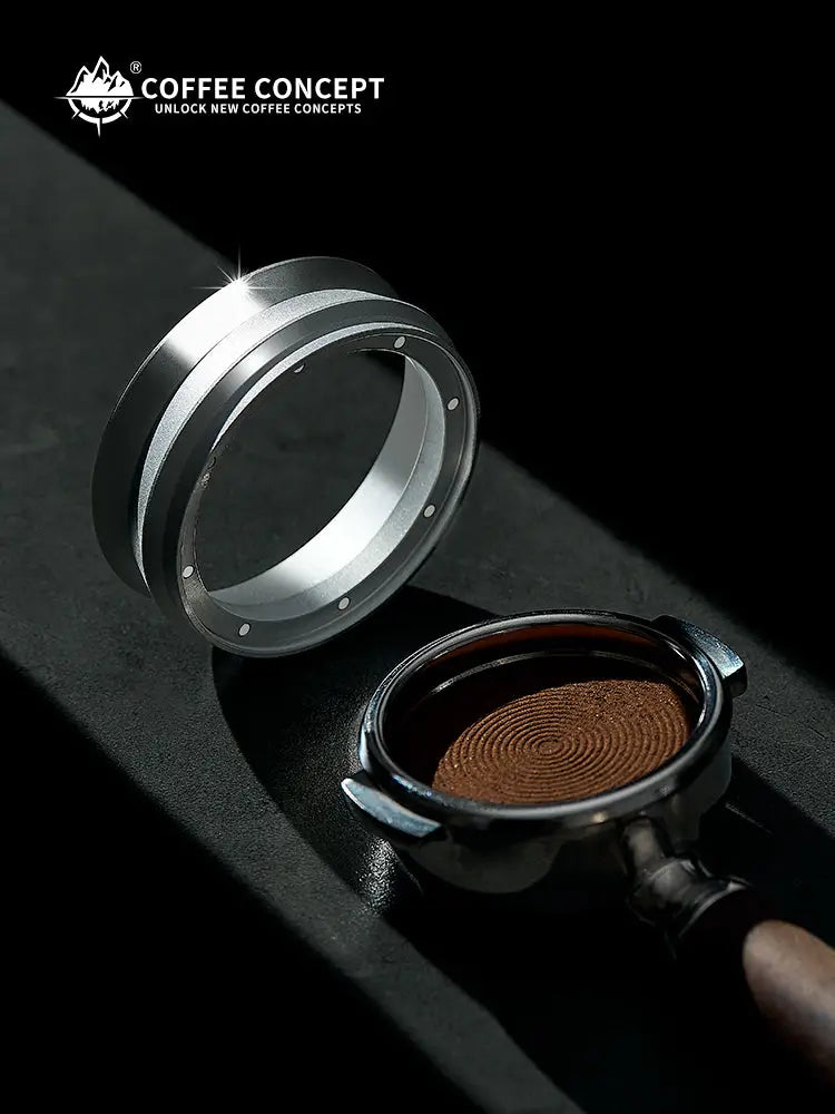 Silver magnetic powder ring near a small coffee catcher tray with brown espresso grounds.