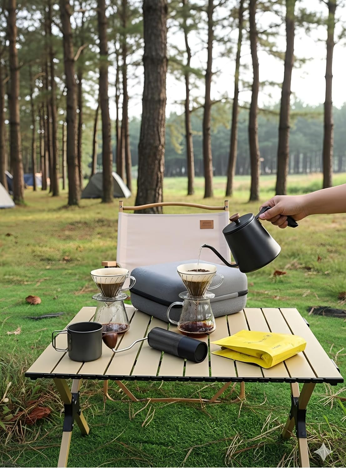 Pour-over coffee kit on outdoor table with kettle, dripper, and stainless mugs
