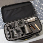 Coffee kit components in foam-lined zip travel bag: kettle, dripper, grinder, and filters