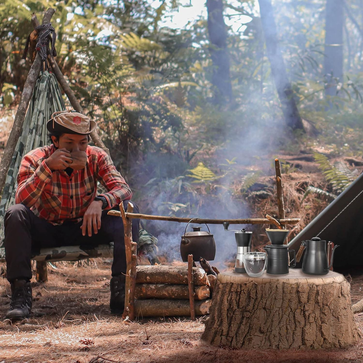 Camping pour-over coffee station with kettle, dripper, and brewing tools on stove