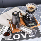 Pour-over coffee kit with stainless kettle, dripper, glass carafe, and grinder scale display