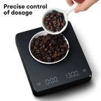 Black digital kitchen scale with LED display and weighing surface