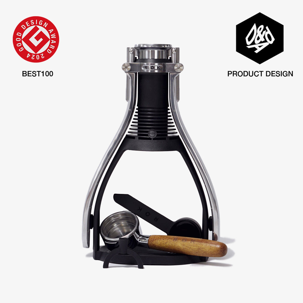 Black manual espresso maker with stainless top and wooden-handled filter press
