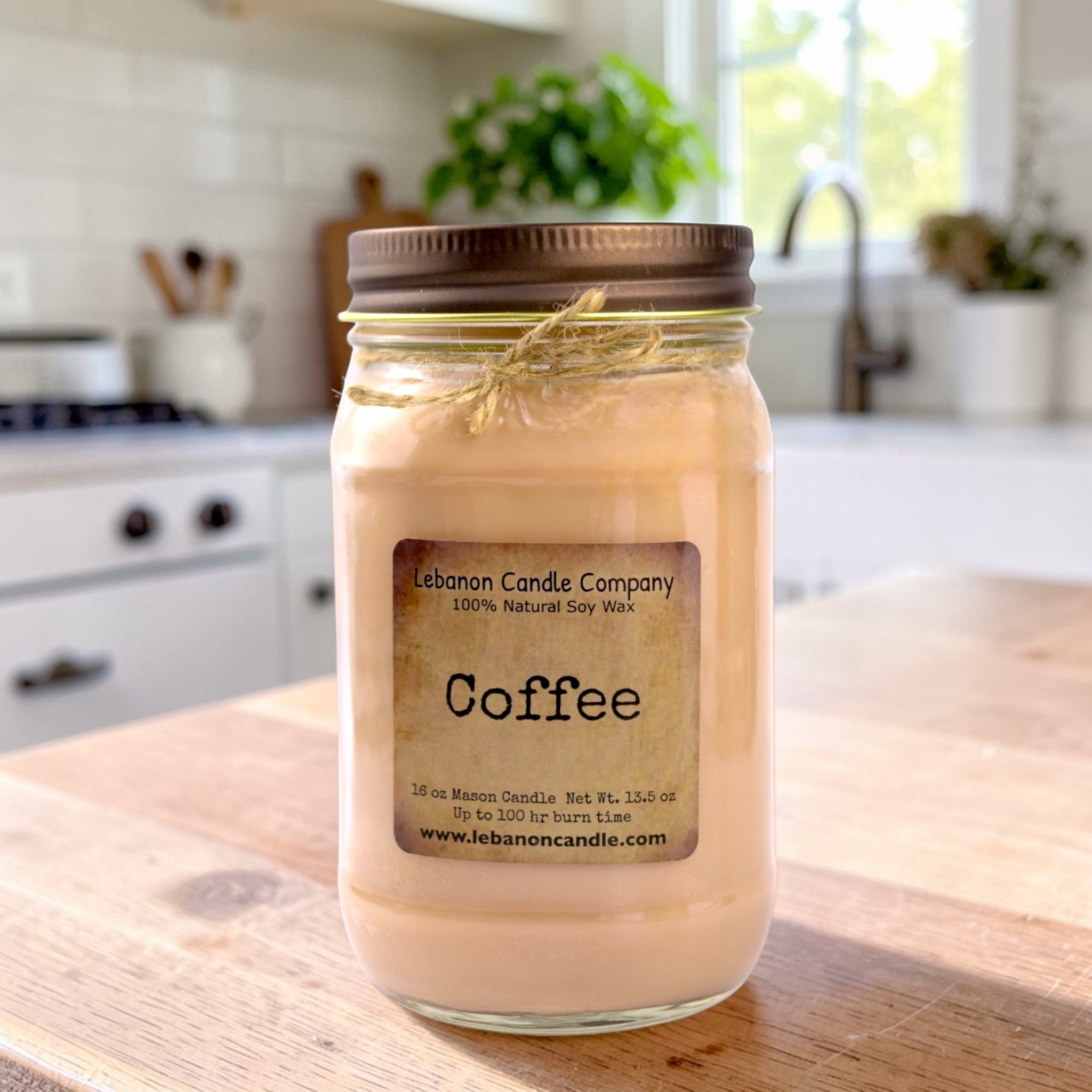 Glass jar soy candle with “Coffee” label and bronze lid
