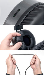Black over-ear gaming headset ear pad being adjusted with hands, visible headband slot
