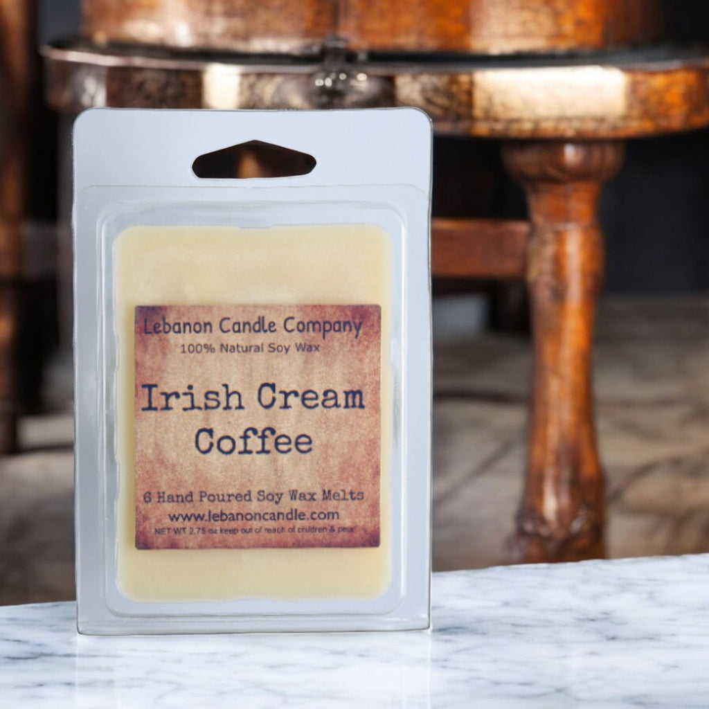 Soy wax melt clamshell labeled 'Irish Cream Coffee' in front of wooden furniture