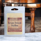 Soy wax melt clamshell labeled 'Irish Cream Coffee' in front of wooden furniture