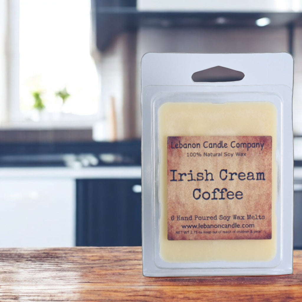 Branded soy wax melt clamshell for 'Irish Cream Coffee' on a wooden table