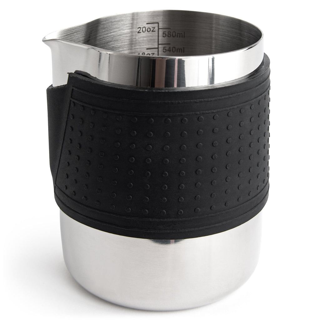 Stainless milk frothing pitcher with black silicone grip and interior measuring marks